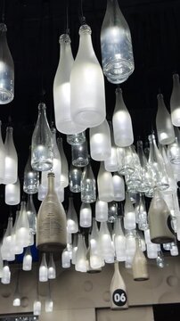 Champagne bottle lanterns hanging from the ceiling. Champagne tasting, Christmas in Reims, Champagne, France, December 25, 2025. High quality 4k footage