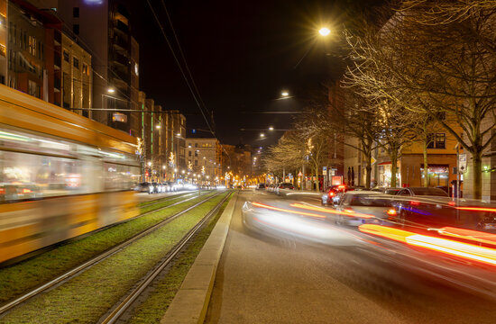 Breiter Weg (Broadway) in Magdeburg, Germany, in the evening during the christmas season, blurred traffic with light traces from tail lights of tram and cars