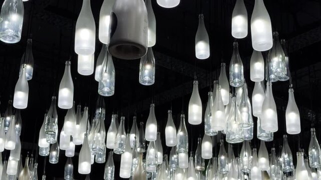 Champagne bottle lanterns hanging from the ceiling. Champagne tasting, Christmas in Reims, Champagne, France, December 25, 2025. High quality 4k footage