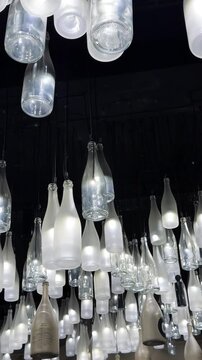 Champagne bottle lanterns hanging from the ceiling. Champagne tasting, Christmas in Reims, Champagne, France, December 25, 2025. High quality 4k footage