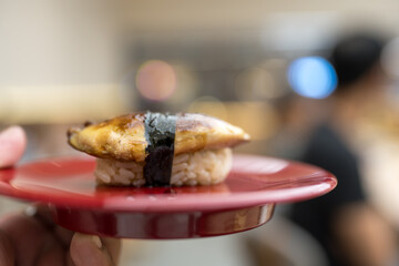 Grilled foie gras sushi or burned foie gras sushi in hand © Dontree
