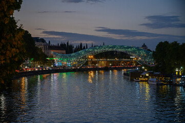 Bridge of Peace Reflecting Lights in Kura River at Night © Михаил Шорохов