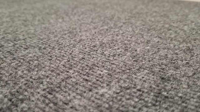 Close-up texture of grey carpet flooring with a shallow depth of field. interior design texture, textile background pattern, office carpet flooring.