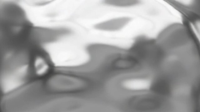 A thin liquid-chrome crescent emerges from the lower center and slowly rotates around an invisible axis, stretching into an elegant asymmetric metallic arc