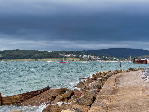 Coastal Sea Wall and Sandy Beach Under Stormy Clouds at Exmouth, Devon