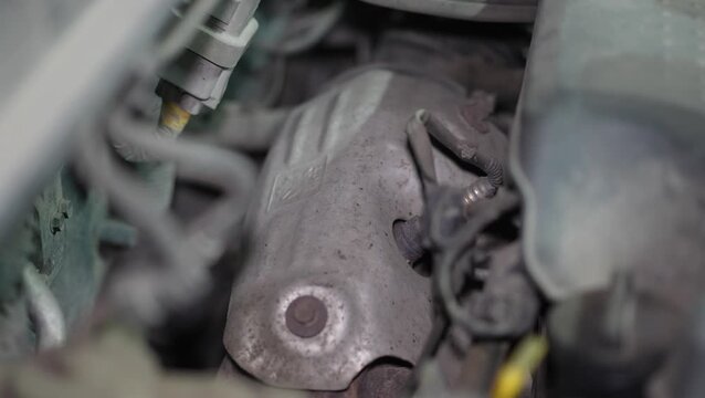 View of an engine exhaust manifold heat shield with oxygen sensor.
