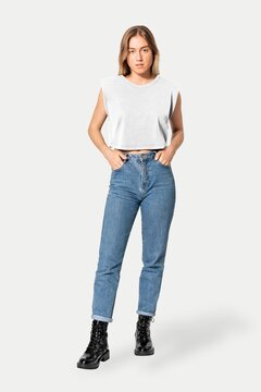 Casual woman in white crop top, jeans, and black boots