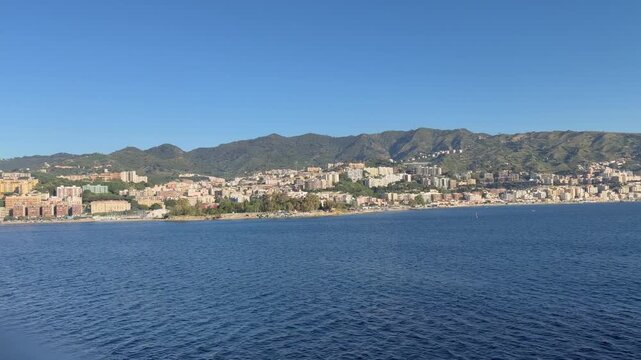 28 April 2026 Italy, Sicily, Strait of Messina, Rione Case Basse - cruising alongside shoreline viewing beach local residential apartments and Spiaggia del Ringo