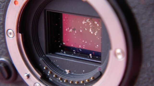 Dust and debris on digital camera sensor, macro shot showing sensor imperfections