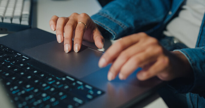 Close-up young Black female programmer coding AI software on multiple screens in night office. Network security, cybersecurity, machine learning, working late, overtime, robotics automation concept.