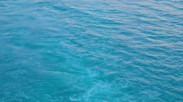Churning Blue Ocean Water Surface with White Sea Foam ripples
