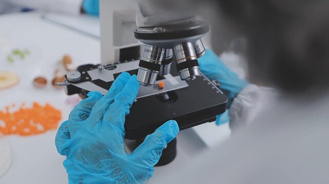 Team Asian scientists in a lab conducting food research using a microscope and lab equipment, showcasing innovation in food science and biotechnology