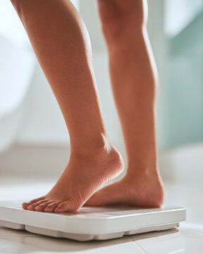 Bare feet stepping onto a bathroom scale for wellness weight tracking - Stepping_onto_a_bathroom_scale_photorealistic_modern_wellness  