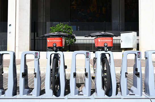LOS ANGELES, CALIFORNIA - 8 MAR 2025: DoorDash E-bikes parked outside The Los Angeles James K. Hahn City Hall East building.