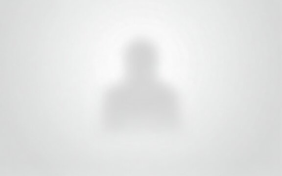 Blurred silhouette person standing against plain light background