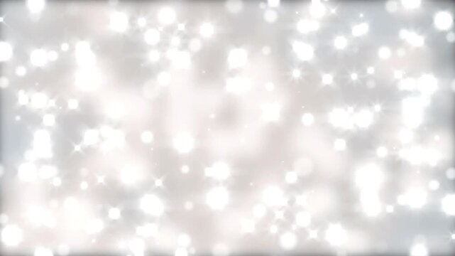 Abstract background featuring white shimmering light particles floating and glowing against a soft gray backdrop with particles sparkling bokeh continuous motion bright