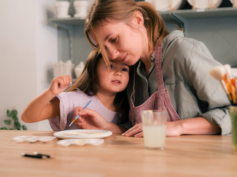 Mother and daughter sharing moment of love and creativity