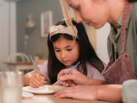 Mother and daughter recreation moment at creative studio