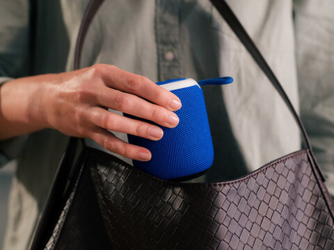 Person taking wireless speaker from bag