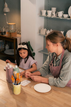 Mother and daughter sharing time on weekend at workshop