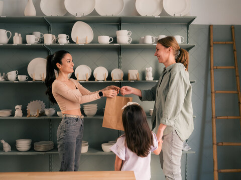 Mother and daughter shopping at ceramic store