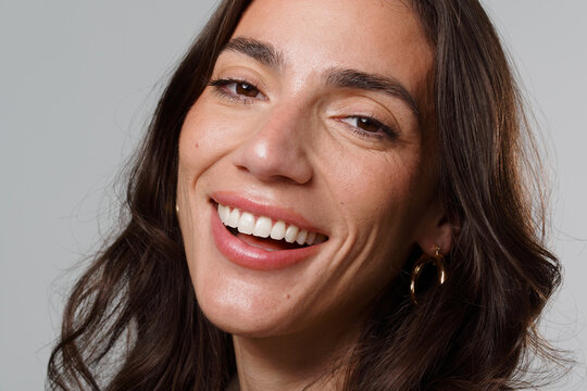 Woman Smiling in a Light-Colored Room During a Portrait Session