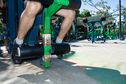 Working out at an Outdoor Gym in the Park on a Sunny Day