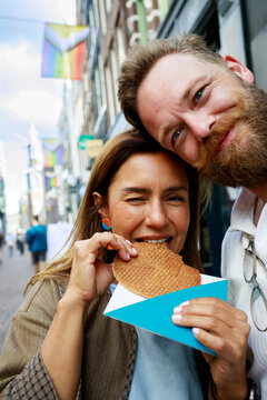 Couple Enjoys a stroopwafel in Amsterdam