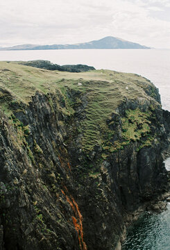 Dramatic Rocky Sea Cliffs and Distant Island