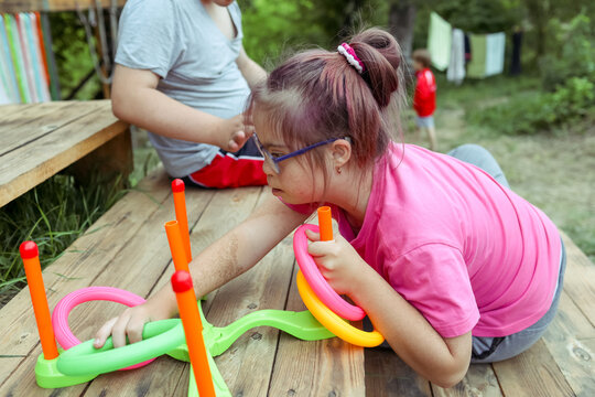 Outdoor activity with a child with Down syndrome at a camp