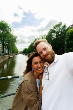 Couple Takes Selfie by Canal in Amsterdam on a Cloudy Day