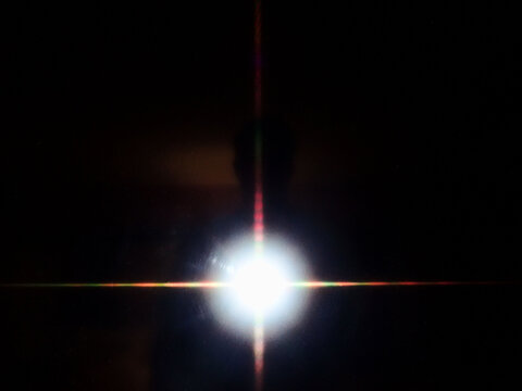 Bright White Light Flare Against Black Background