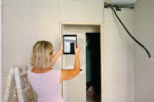 Architect photographing doorway during renovation inspection