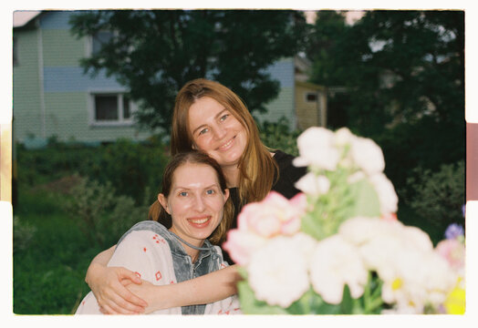 Friends hold each other close as twilight settles in