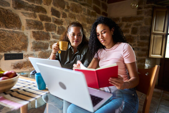 Women collaborating working from home with laptops