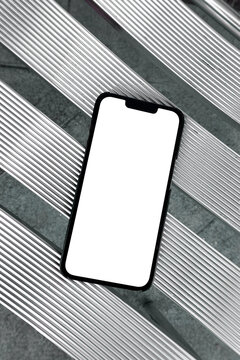 Smartphone with Blank White Screen on Metallic Outdoor Seating Surface