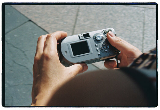 Hands Holding Compact Camera