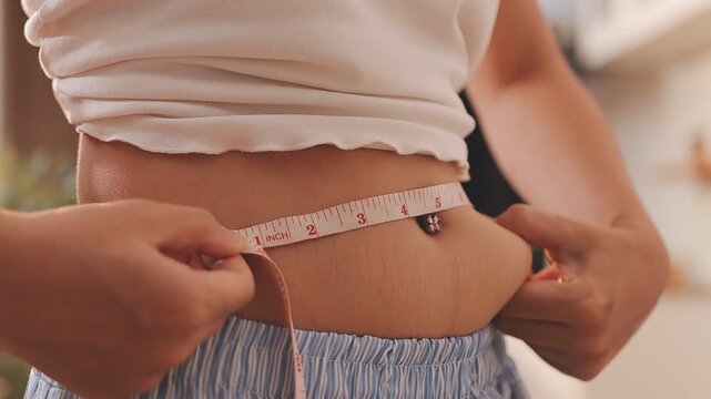 fat woman, fat belly, chubby, obese woman hand holding excessive belly fat with measure tape, woman diet lifestyle concept