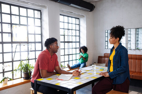 Colleagues Having a Conversation During a Casual Office Meeting