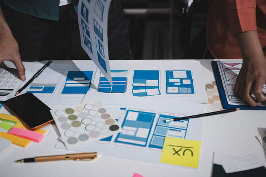 UI designer and UX developer brainstorm idea to design the application appearance in the early stage. Creative digital development agency. UX UI concept