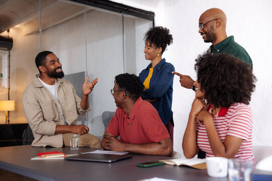 Smiling Team in Casual Business Meeting Discussion