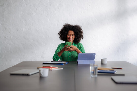 Smiling Woman Working Remotely With Tablet And Phone