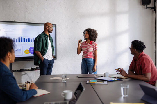 Diverse Team Giving Presentation in Casual Business Meeting