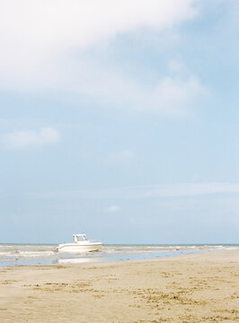 Solitary boat beached on a tranquil sandy shore