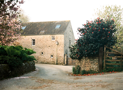 Quiet country road by a stone house in spring