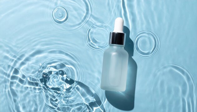 Blank glass serum dropper bottle standing in shallow rippling water with bright caustic reflections