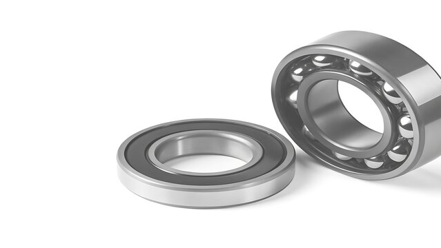 Ball bearings resting on a clean white studio background surface.