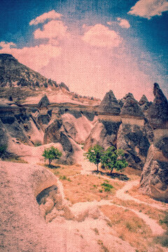 Turkey, Europe: graphic reworking in fairy tale style on a canvas texture of the Fairy Chimneys (Peri Bacaları), extraordinary conical rock formations of volcanic origin in Cappadocia