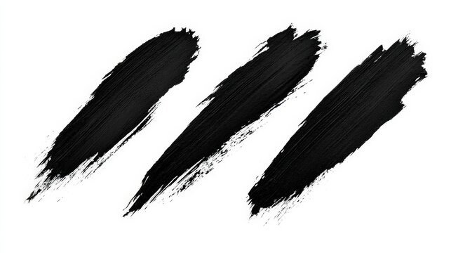Three textured black paint brush strokes isolated on white background. Useful for artistic graphic design elements and abstract creative compositions.