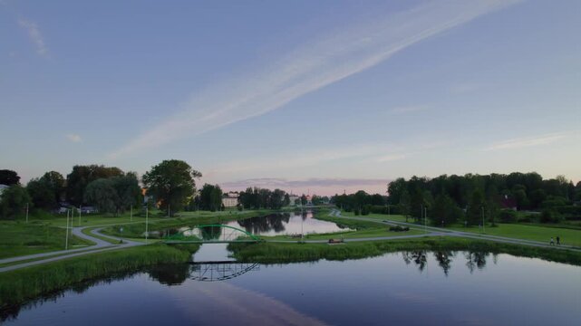 Aerial trucking shot to the right at dusk capturing Pedeli river in Valga